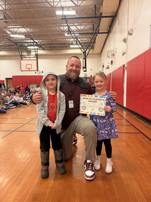Mrs. Roloson poses with boy and girl from winning class