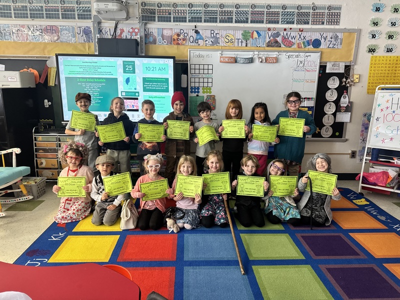 class photo of students holding up signs