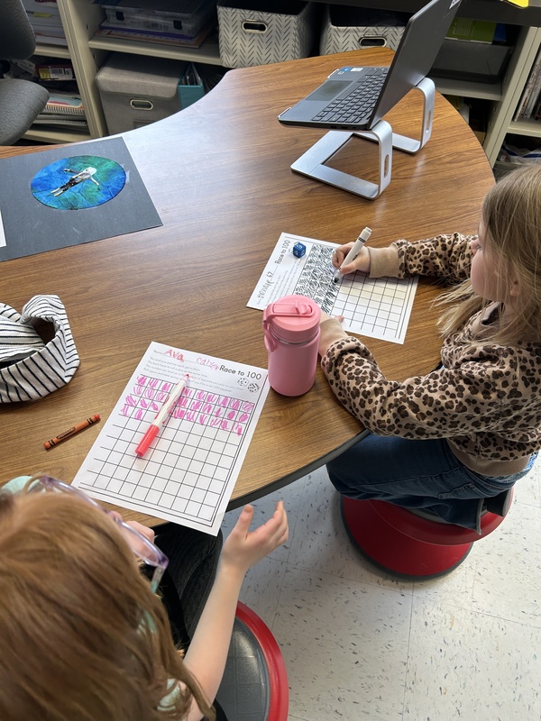 students doing number charts at tables
