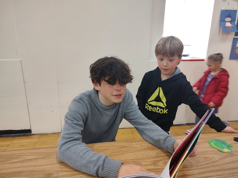 two boys playing game at table