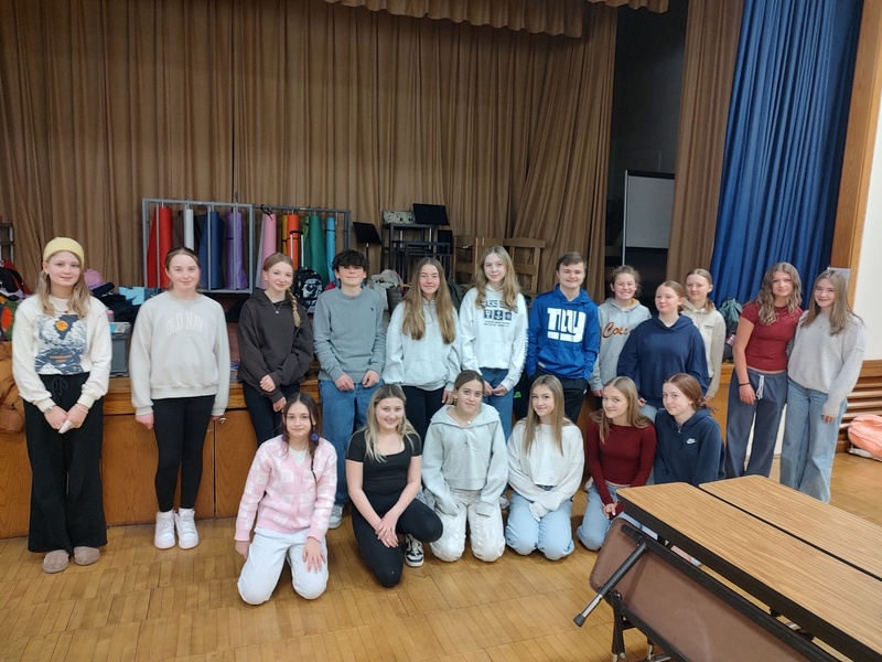 CMS Service Club Members pose for  photo in elementary school cafeteria