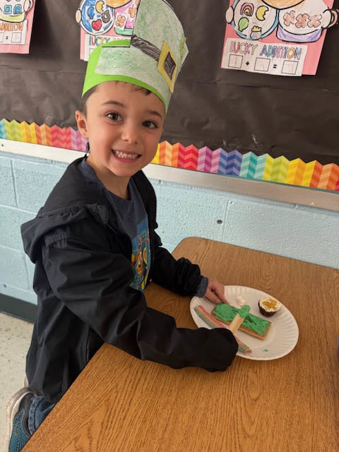 boy making rainbow and pot of gold cookie