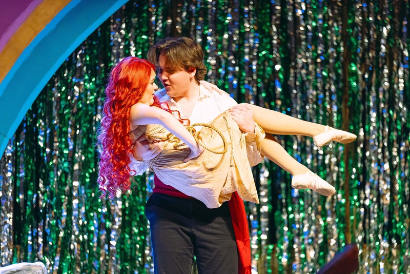 boy holding girl on stage in Little Mermaid