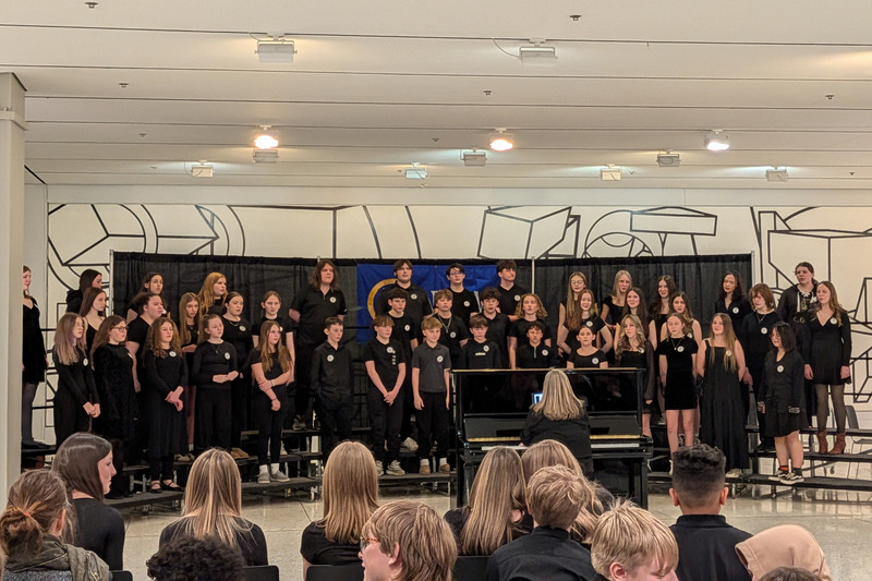 grade 7/8 chorus performing on the South Concourse