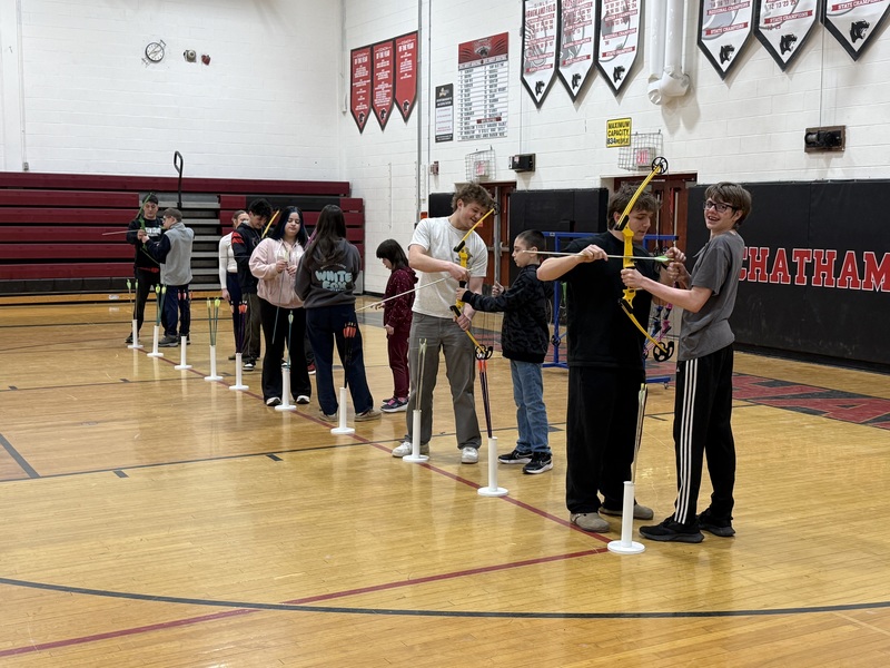 student standing in line learning how to draw bow and arrow