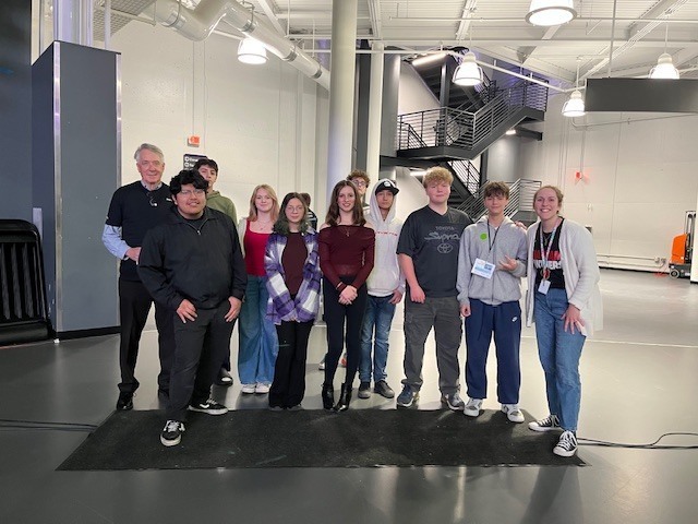 Introduction to Business Class poses for group photo at stock market challenge