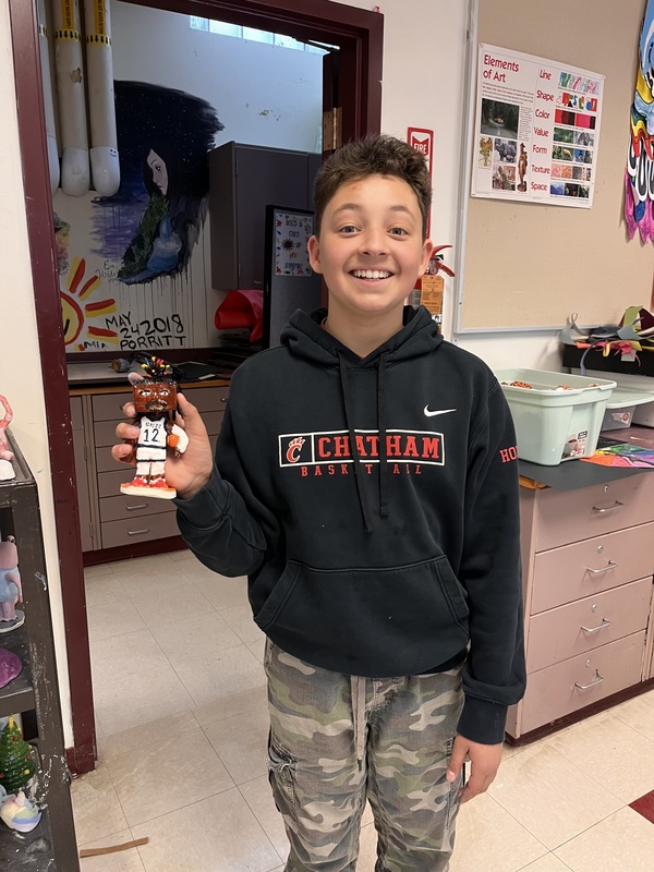 boy holding bobblehead he made