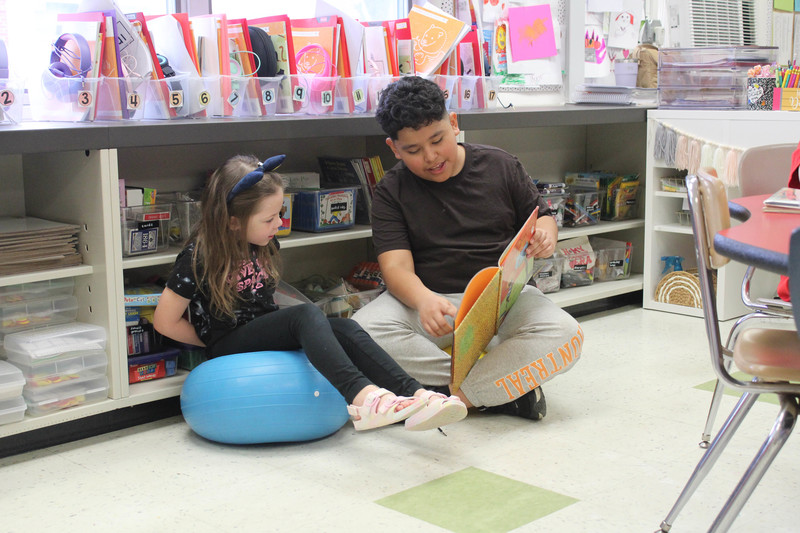 boy reading to girl