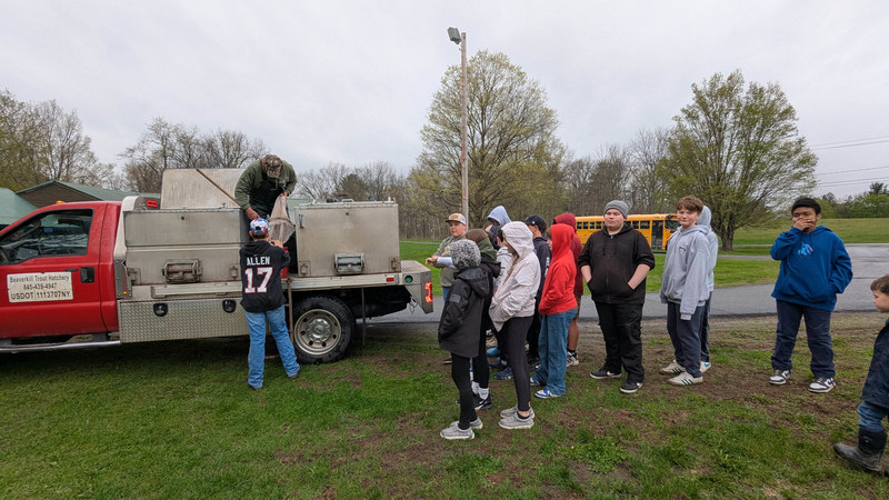fishing club helping offload trout from stocking truck