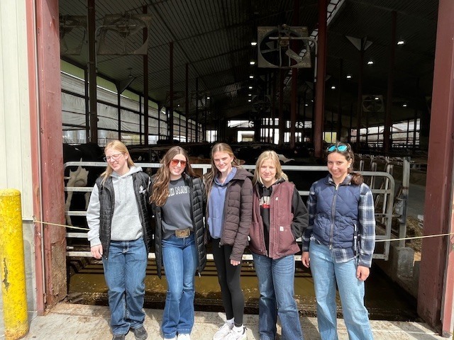 students outside cattle barn