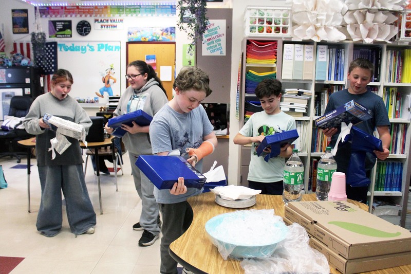 students unwrapping gifts