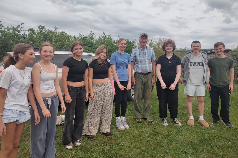 group photo of Builders Club with senior residents in field