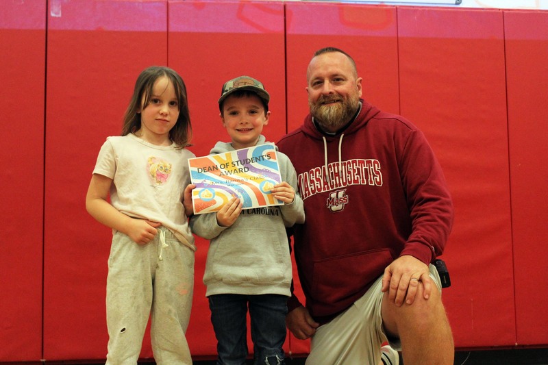 man poses with girl and boy holding Dean of Student's Award