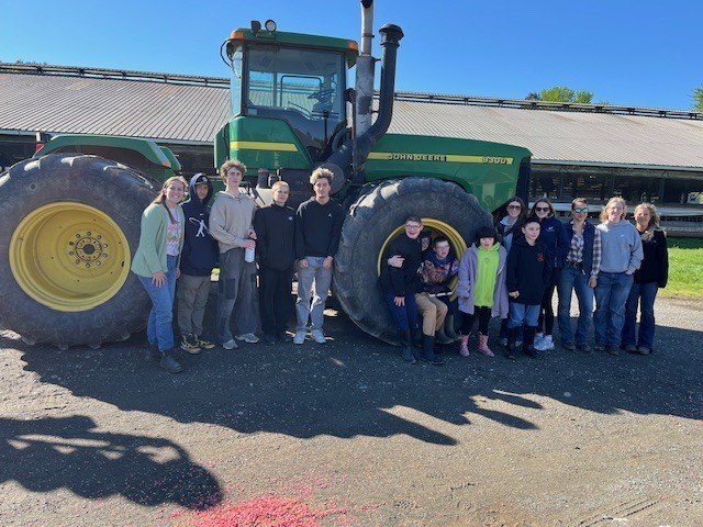 students pose with tractor