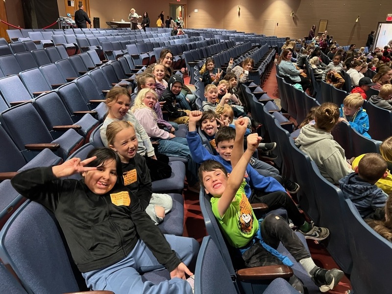 students sitting in theater seats