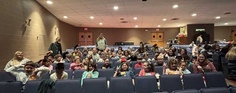 students sitting in theater seats