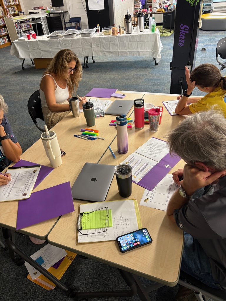 Teachers working in a group at a school library.