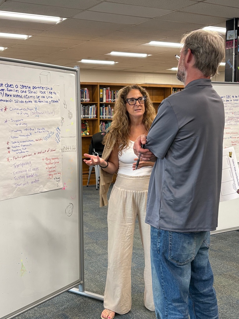 Teachers working in a group at a school library.