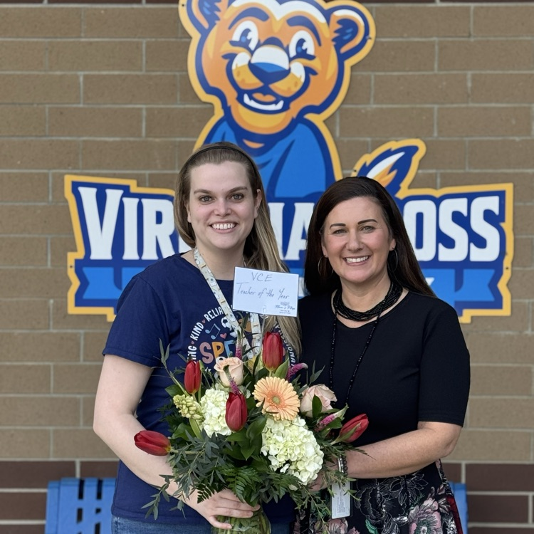 photo of two women holding flowers 