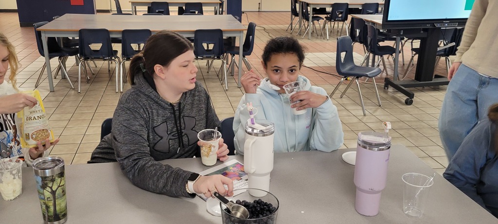 Middle School students eating yogurt parfaits