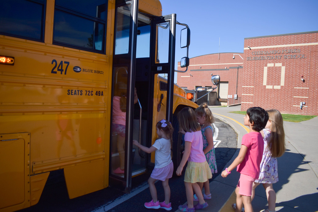 students getting on bus