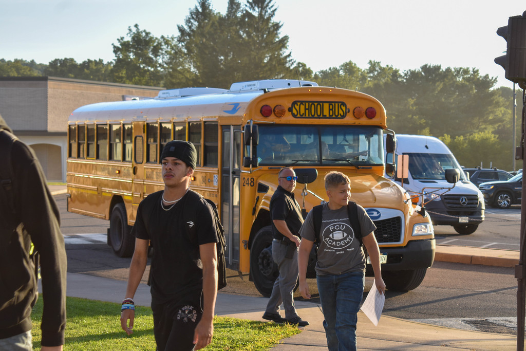 students in front of bus