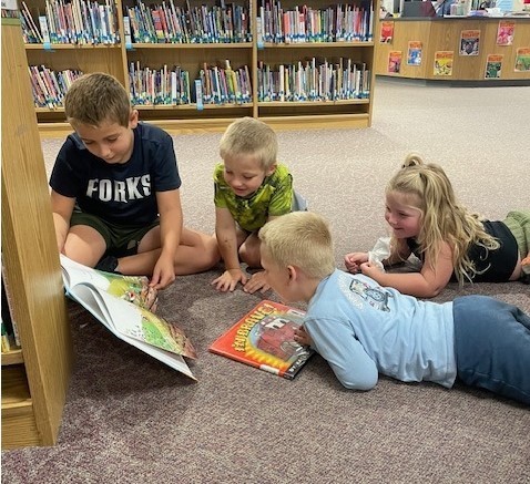 fourth grade students reading to pre-k students