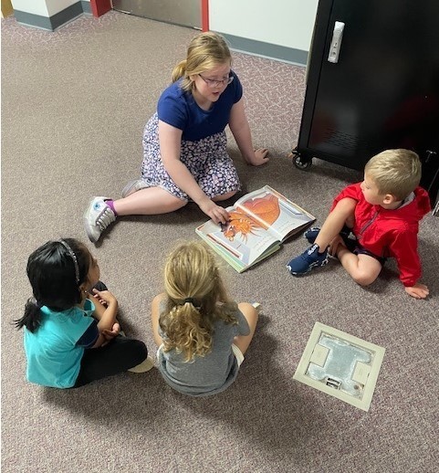 fourth grade students reading to pre-k students