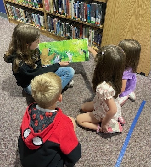 fourth grade students reading to pre-k students