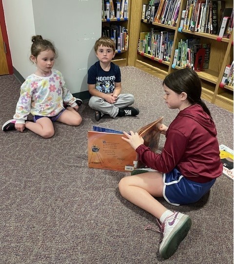 fourth grade students reading to pre-k students