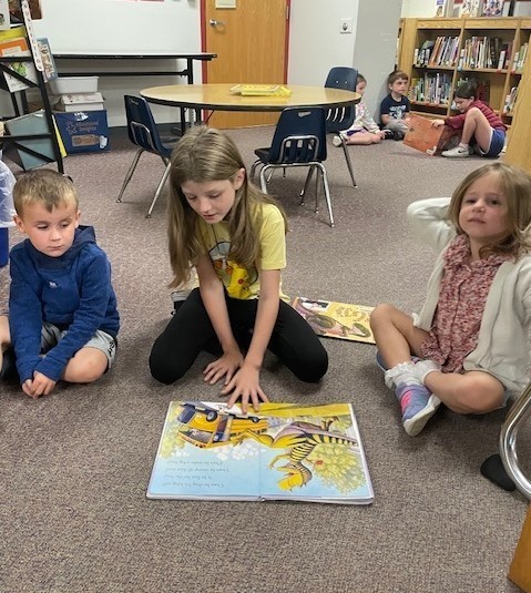 fourth grade students reading to pre-k students
