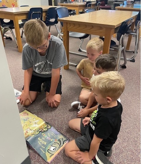 fourth grade students reading to pre-k students