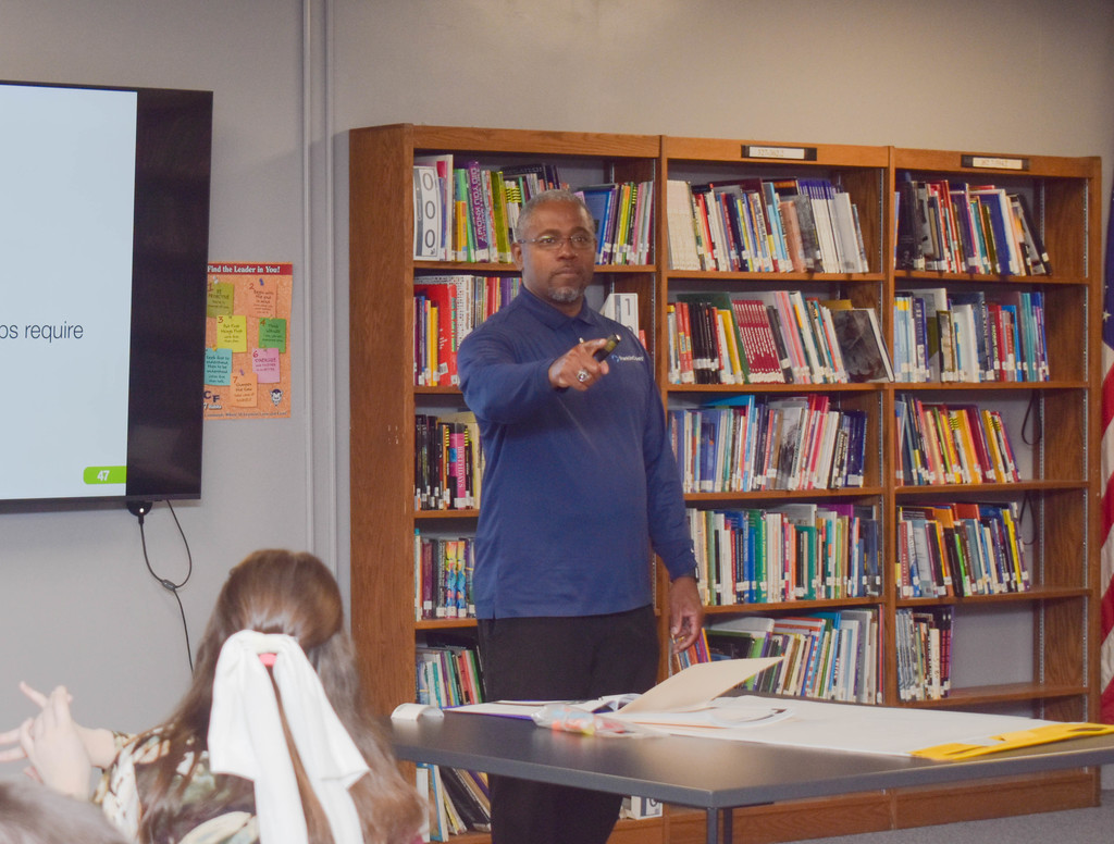 workshop presenter speaking to group of students