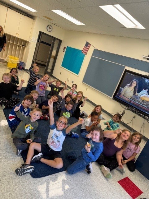 students sitting on floor in classroom