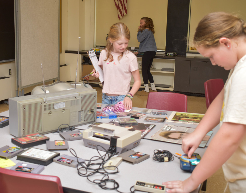 students looking at old video games
