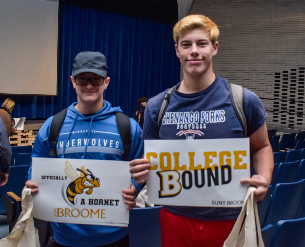 students holding suny broome poster