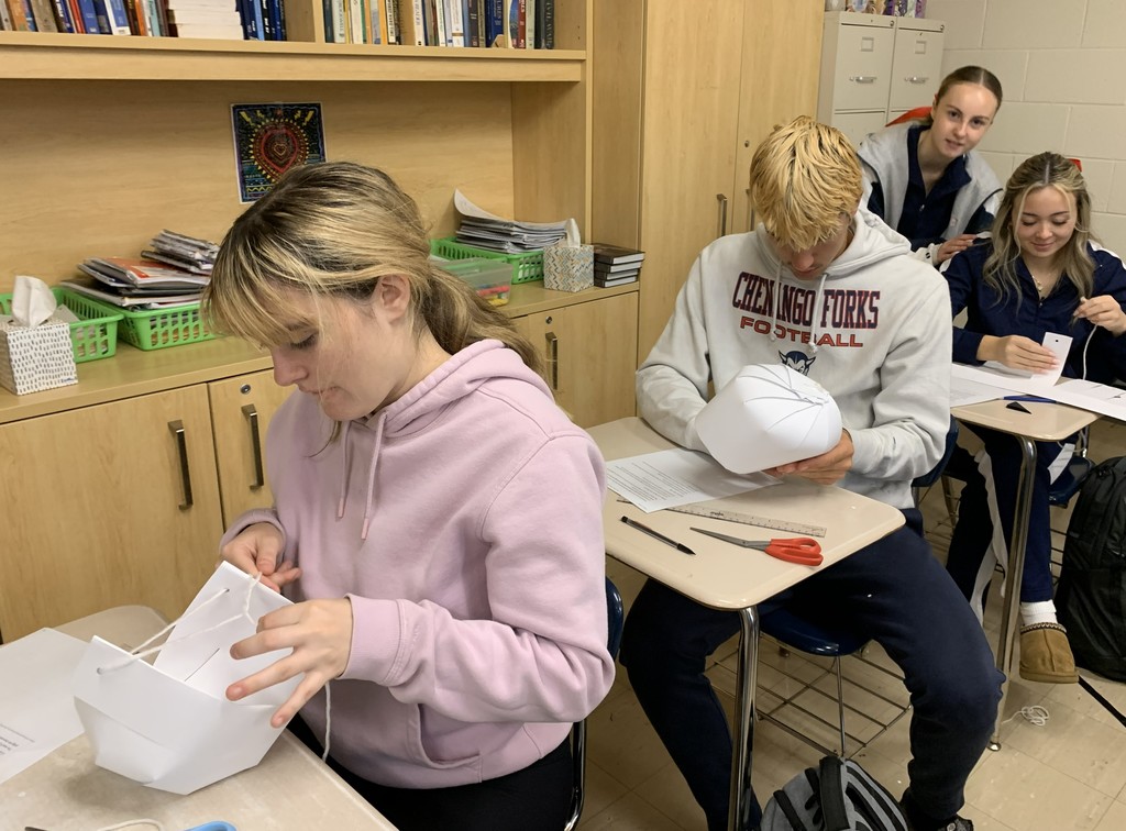 students in creating hats