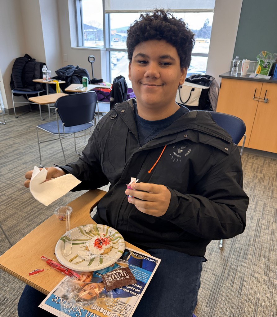 student decorating cookie