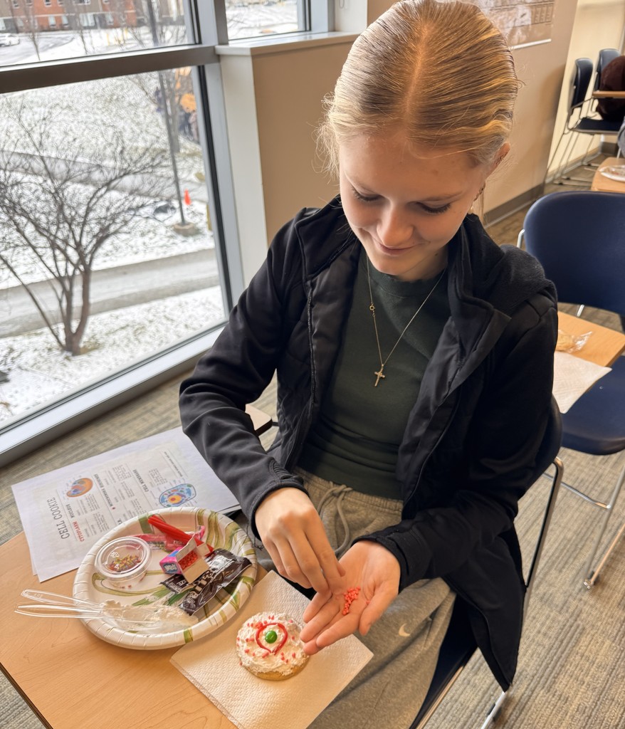 student decorating cookie
