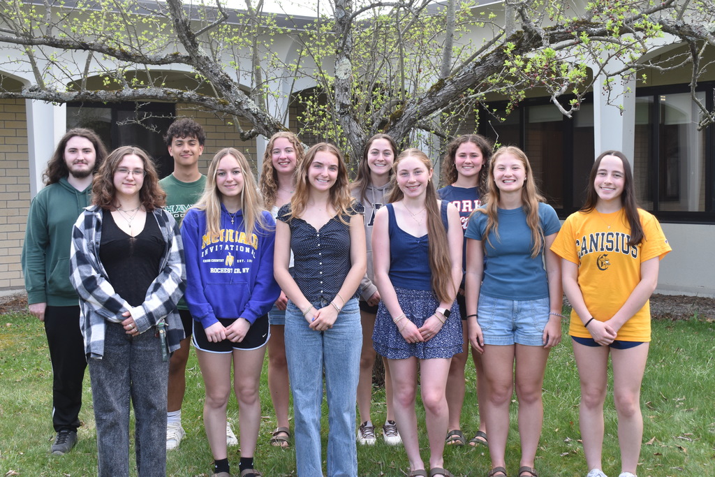 high school students standing outside in front of tree