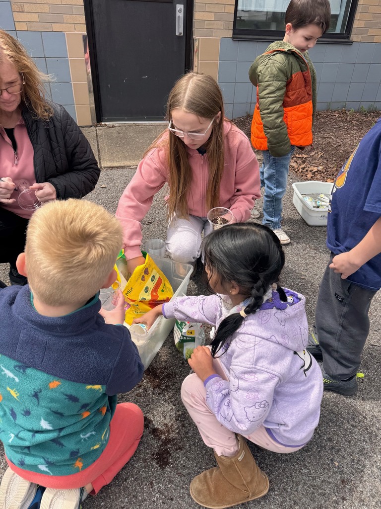 middle school and pre-K students planting in cups