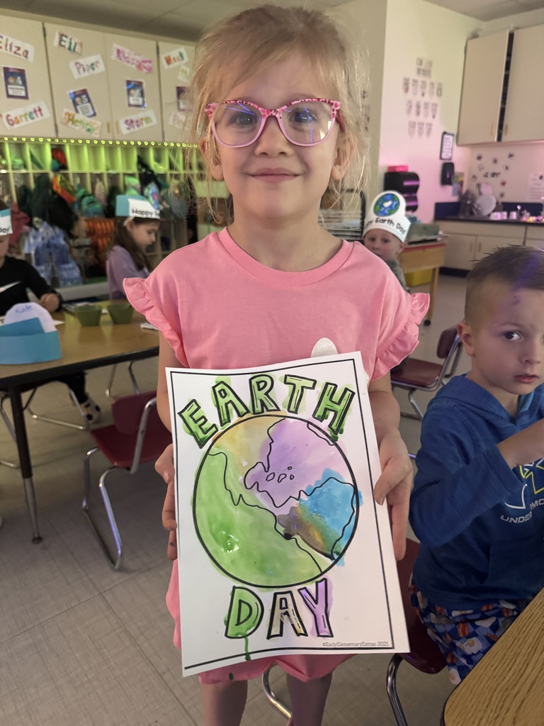 student with earth day artwork