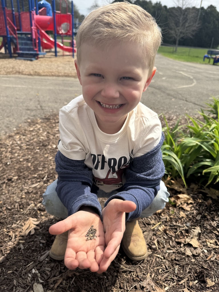 student planting flower seeds