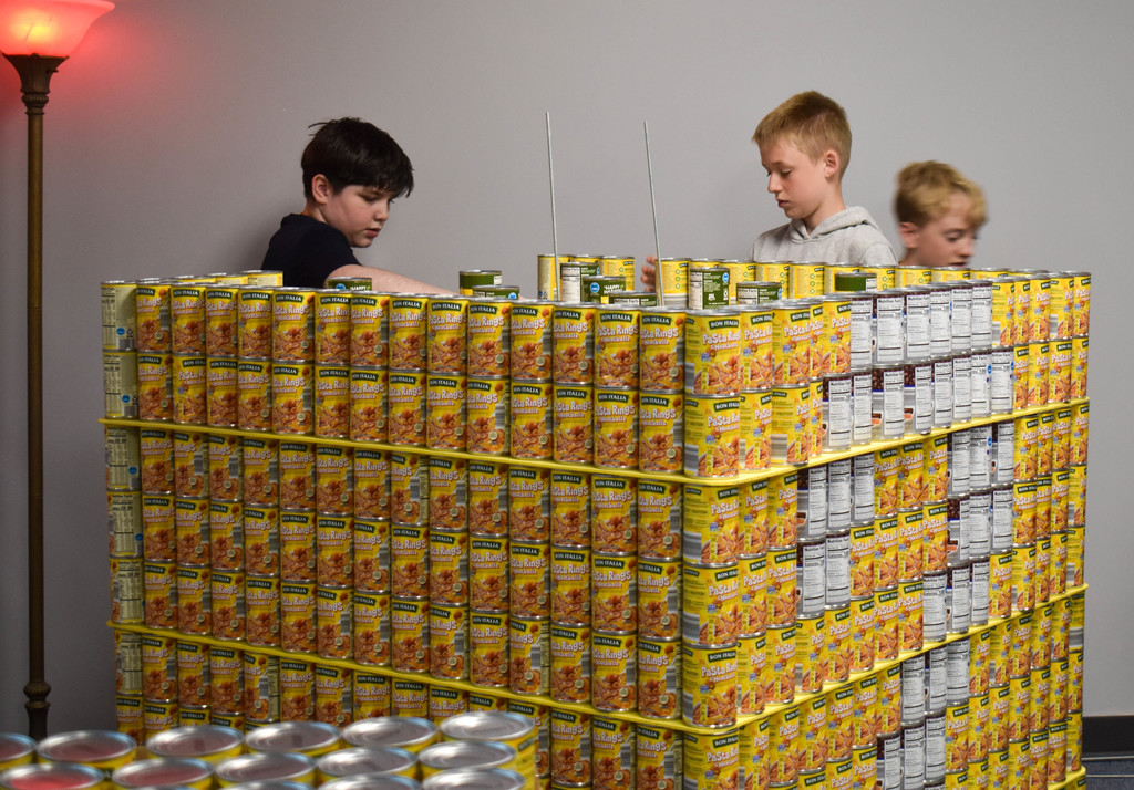 students building structure with cans