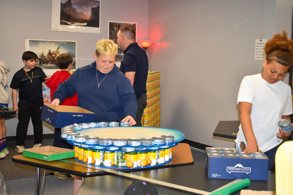 students building structure with cans