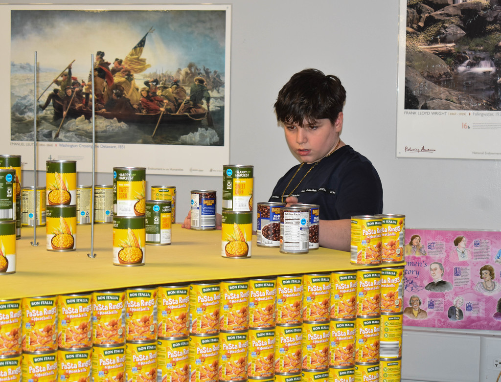 students building structure with cans