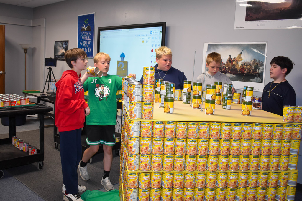students building structure with cans