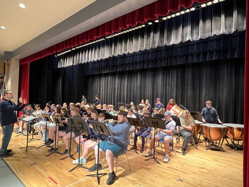 high school band performing for elementary students 