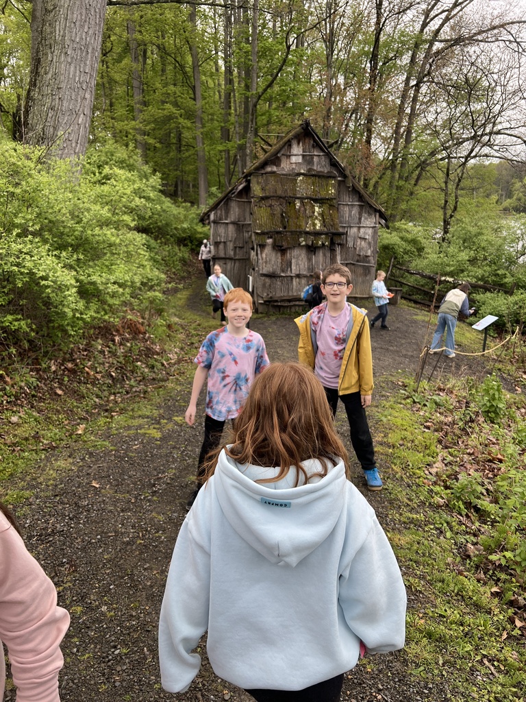 elementary students in front of old home