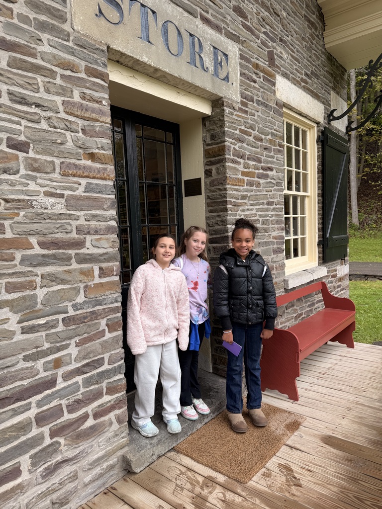 elementary students in front of building